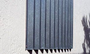 A close up of a radiator on a white wall.