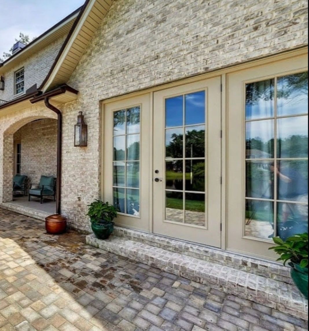 A brick house with a patio and french doors