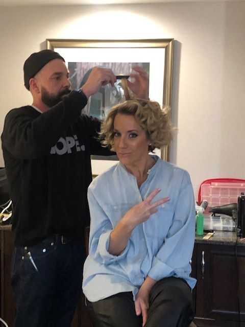 a woman is getting her hair done