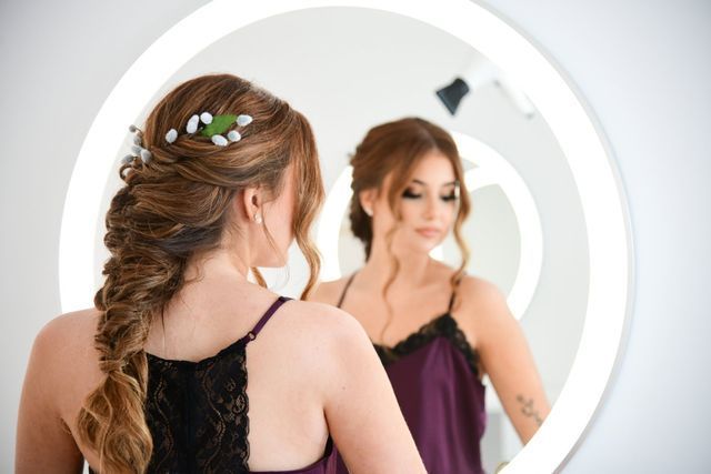 a woman is looking at her reflection in a mirror