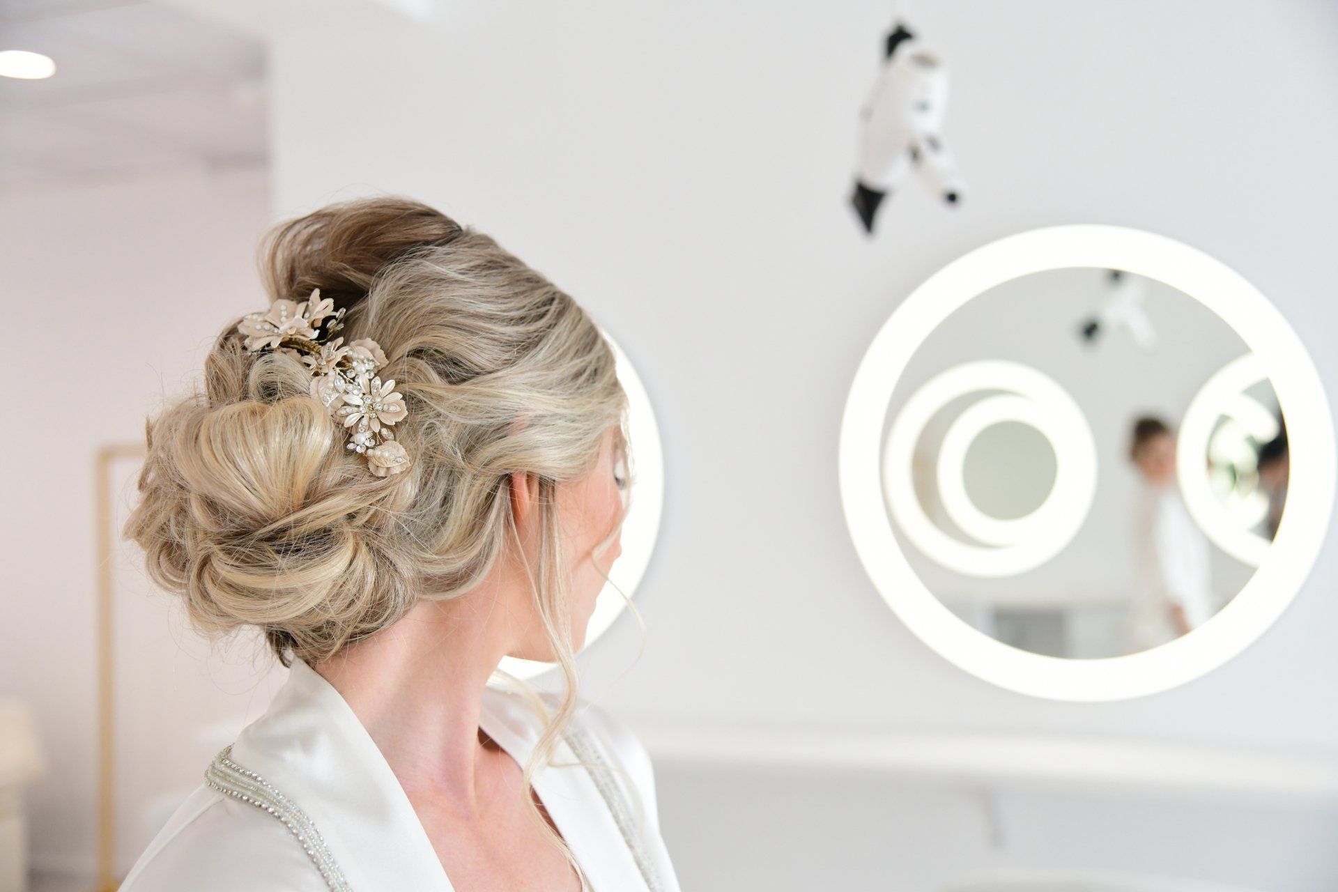 a woman is getting her hair done in front of a mirror