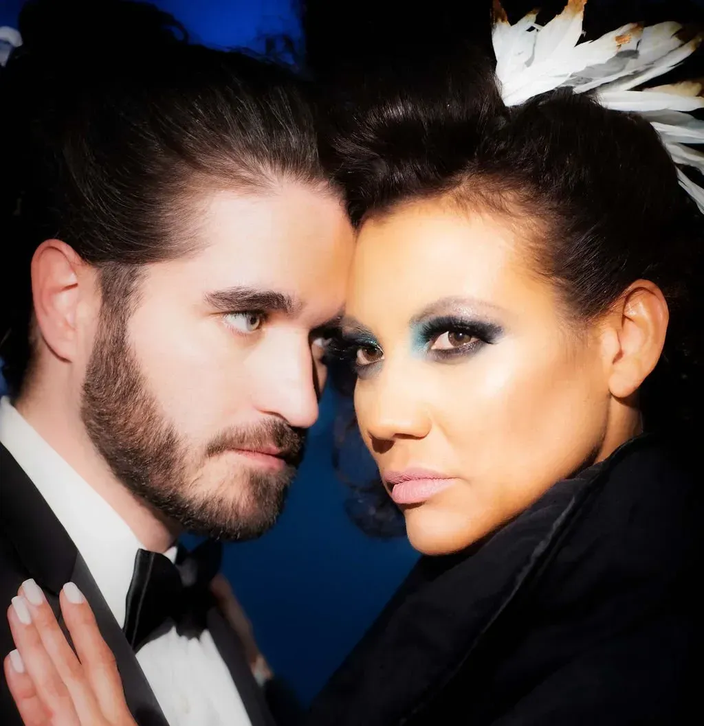 a man and a woman are looking at each other