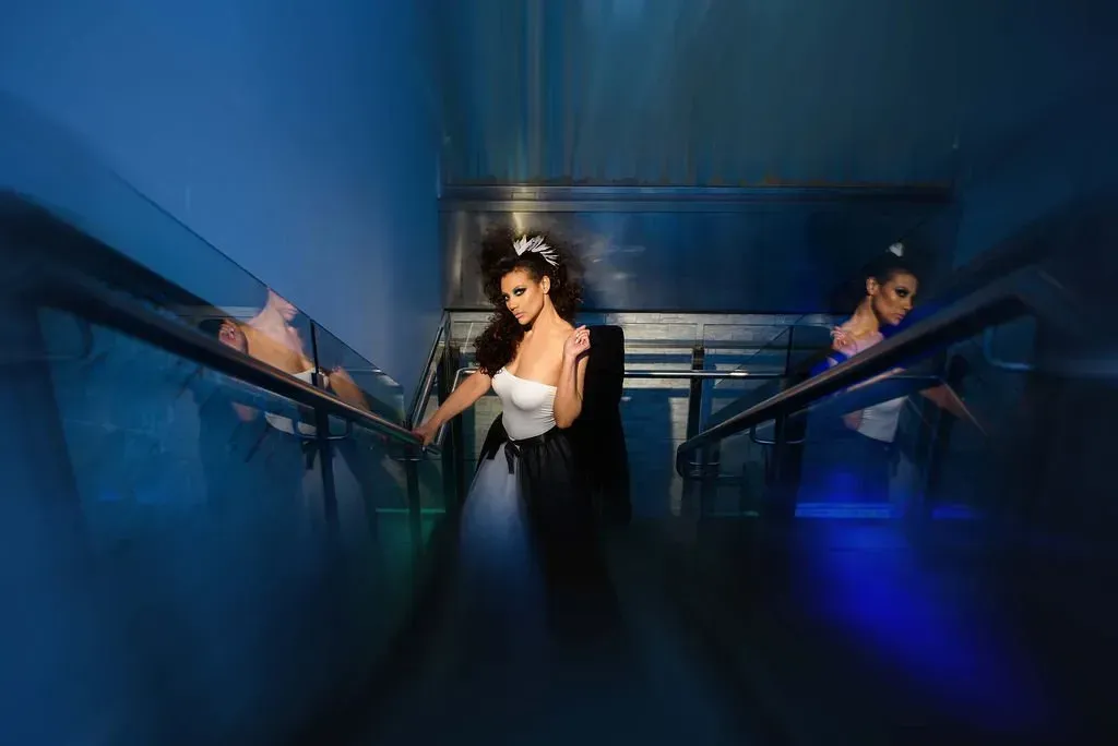 a bride and groom are standing on a set of stairs