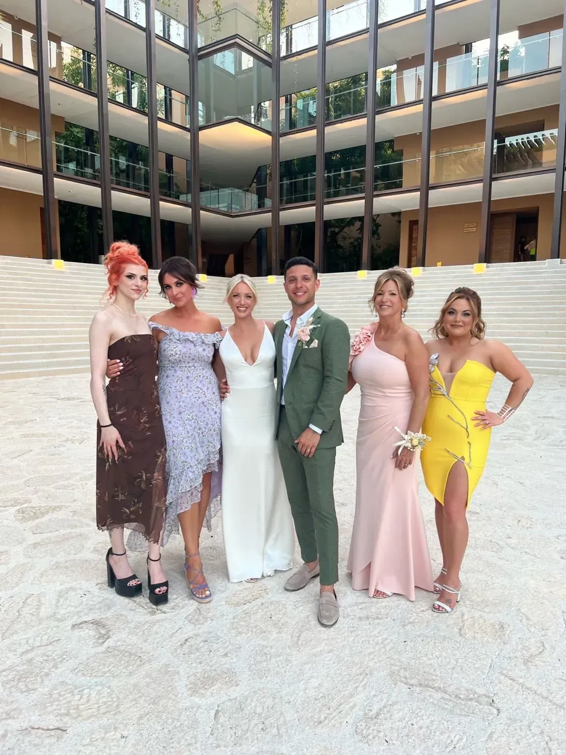 a group of people standing next to each other in front of a building