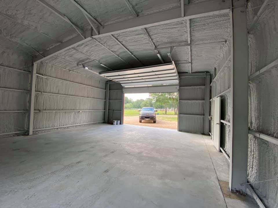 A car is parked in a garage with the door open.