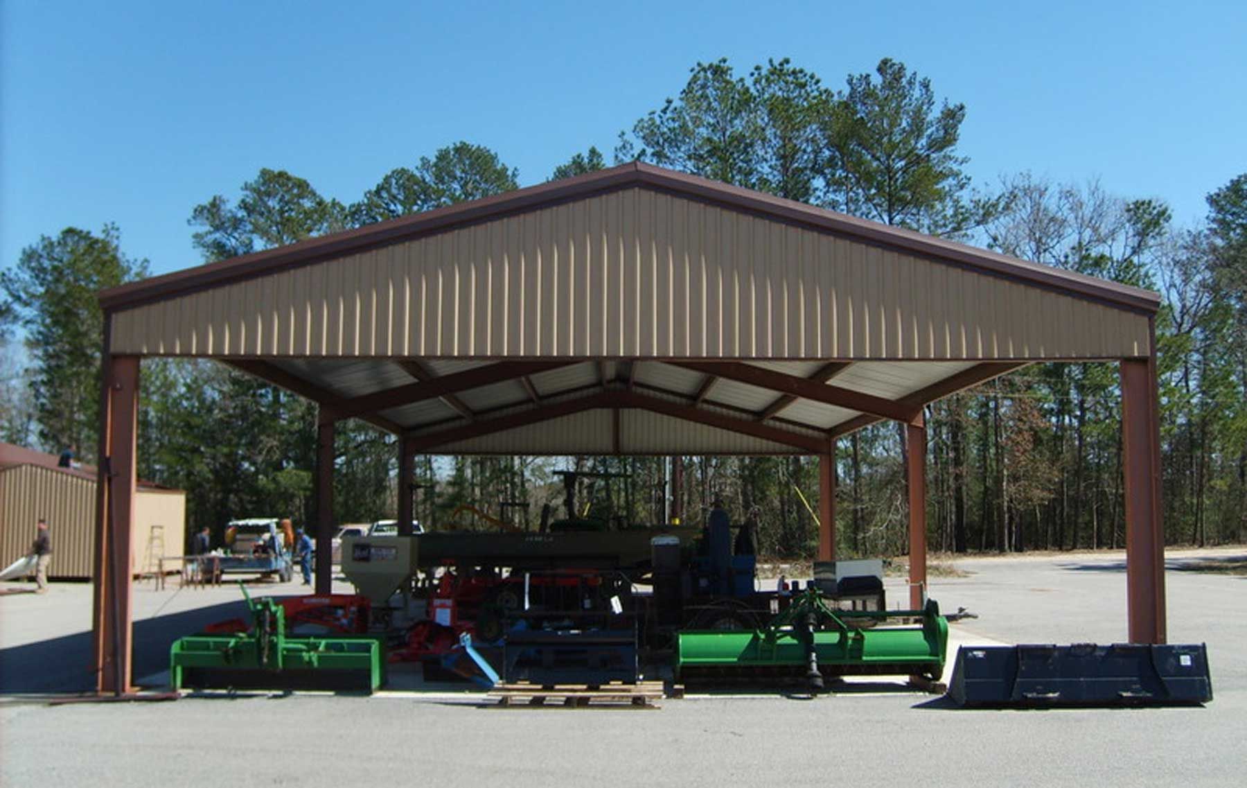 A shed with a green tractor inside of it