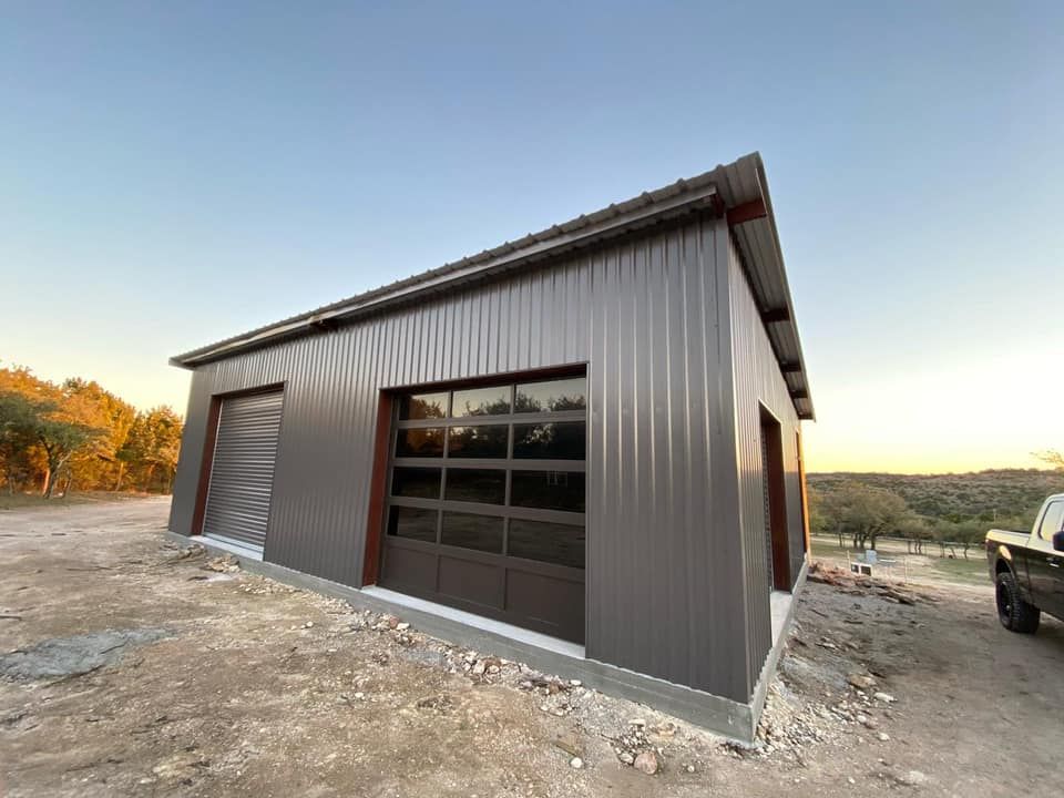 A garage with a large garage door and a truck parked in front of it.
