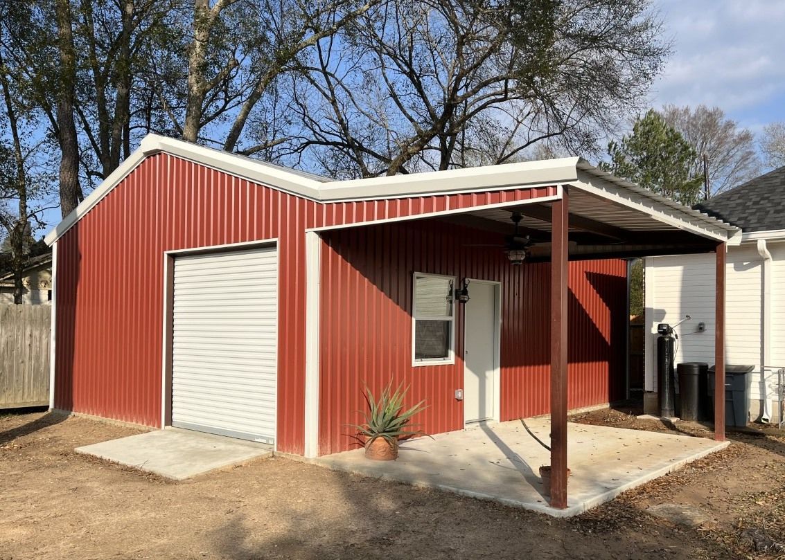A red and white metal garage with a covered porch.