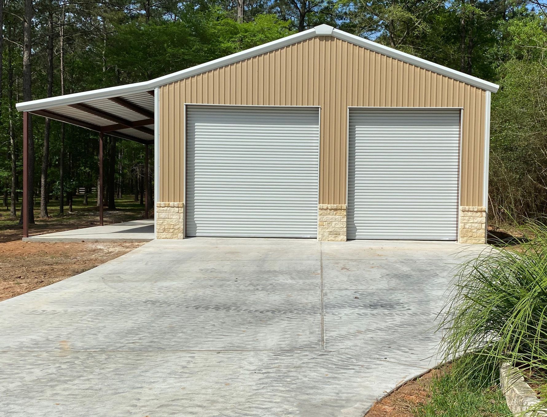 A garage with two garage doors and a carport