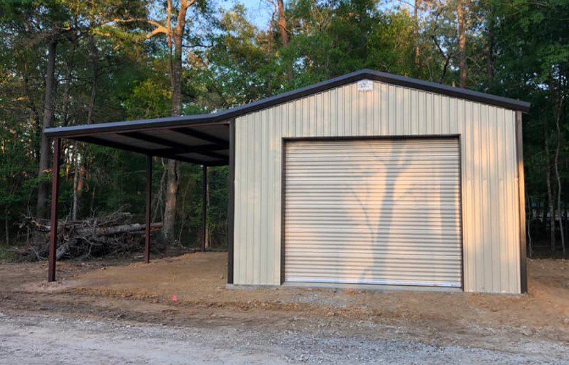 A metal garage with a carport attached to it.
