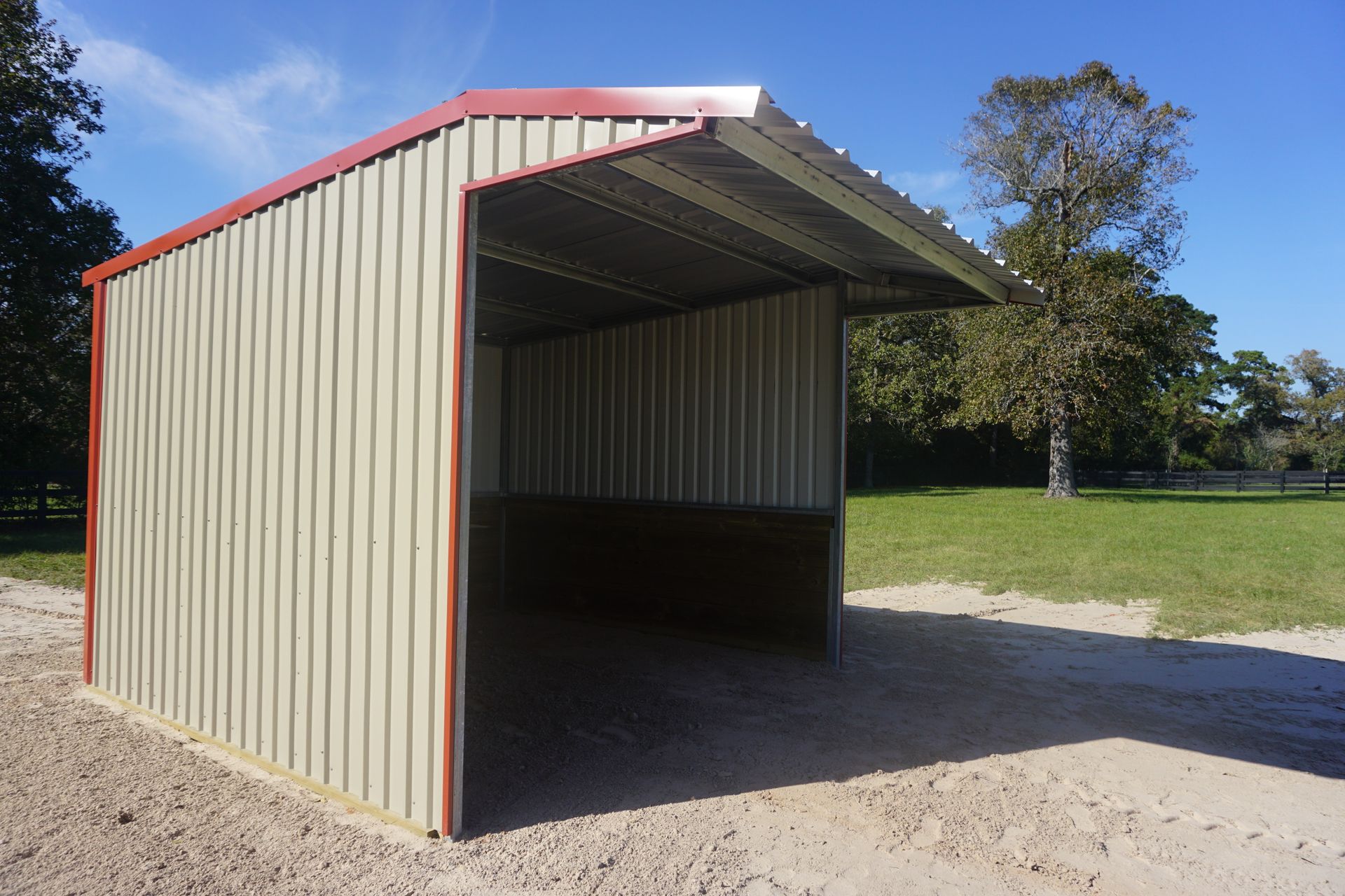 A shed is sitting in the middle of a dirt field