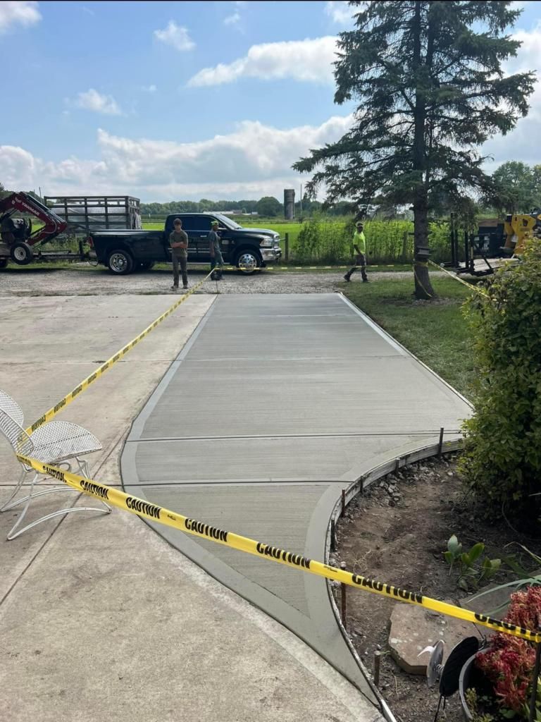 A concrete driveway is being built in a parking lot.