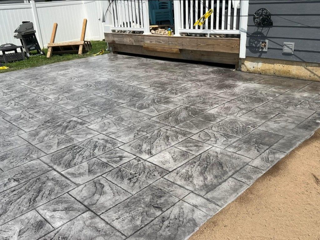 A concrete patio is being built in front of a house.