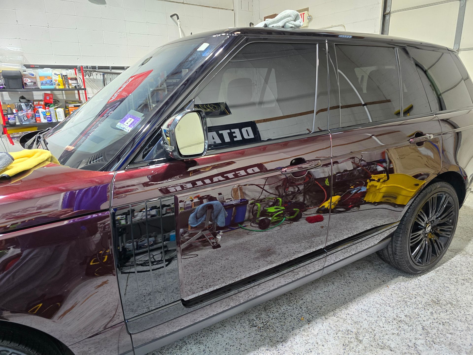 A red range rover is parked in a garage.