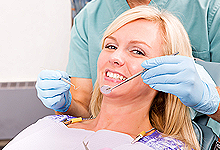 Woman being attended by a dentist