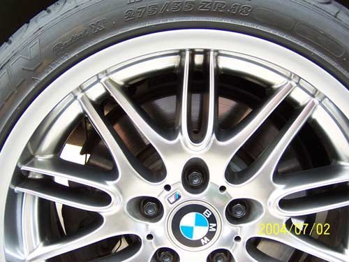 BMW car wheel with silver spokes and a tire.