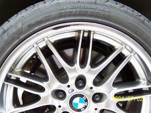 Close-up of a silver BMW wheel and tire with black sidewall.