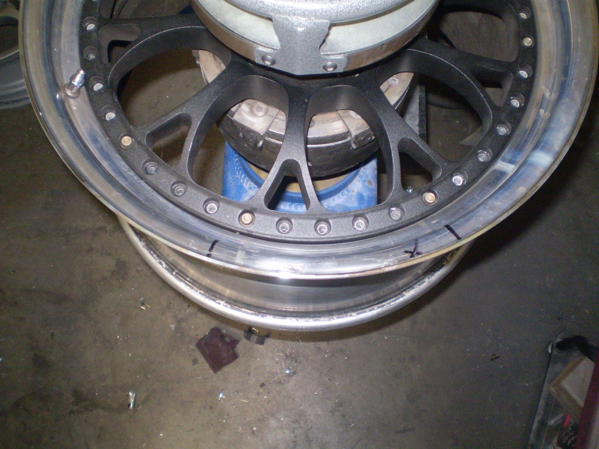 Close-up of a black and silver car wheel, possibly being worked on.