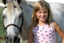 Girl beside a horse