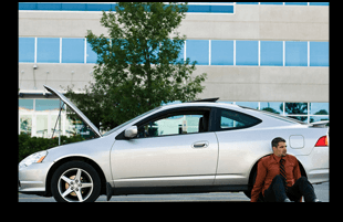 Man sitting with the repaired car