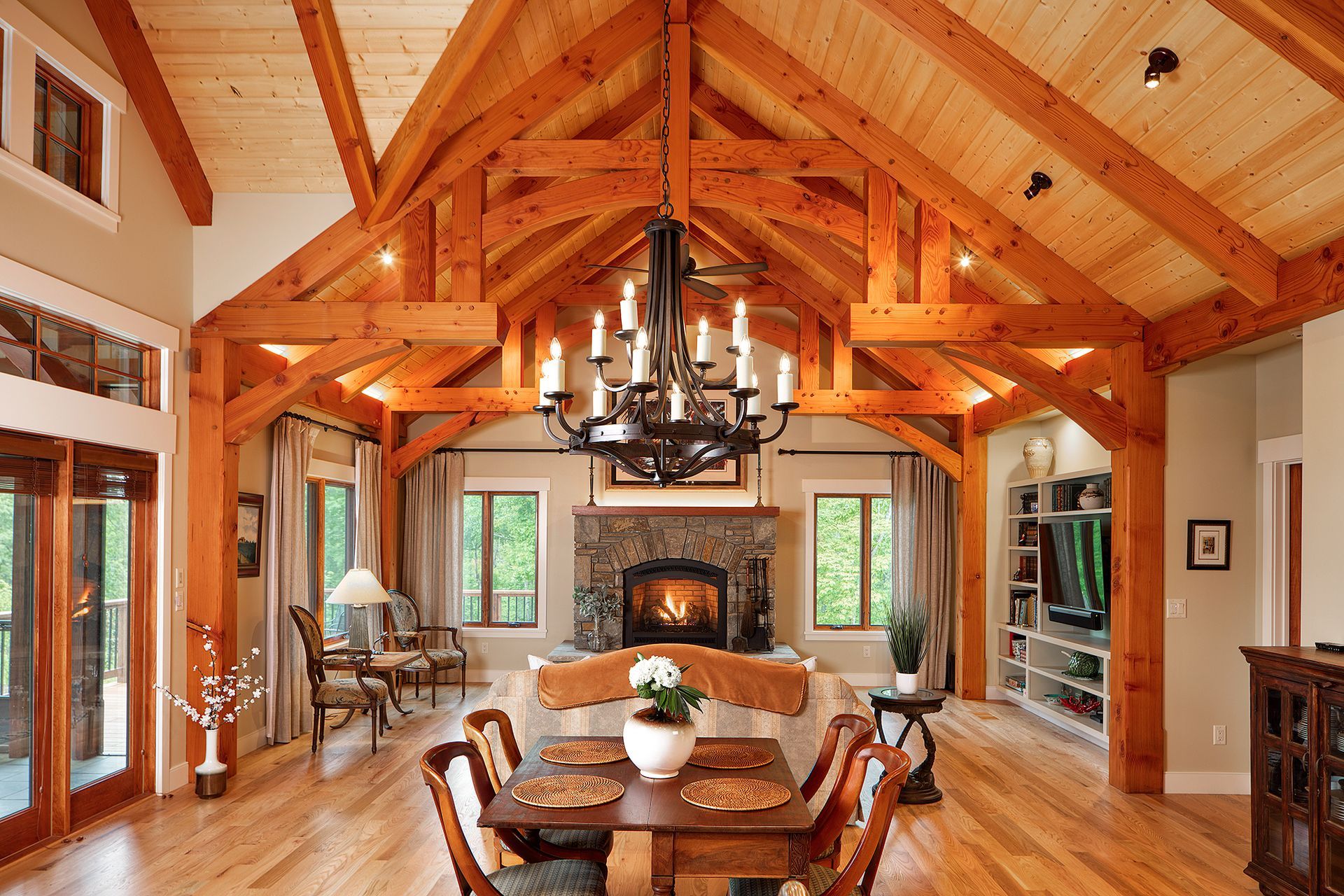 A living room with wooden beams and a fireplace.