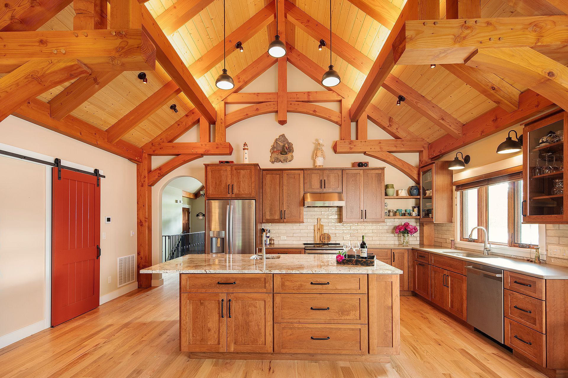 A large kitchen with wooden cabinets and a wooden ceiling.