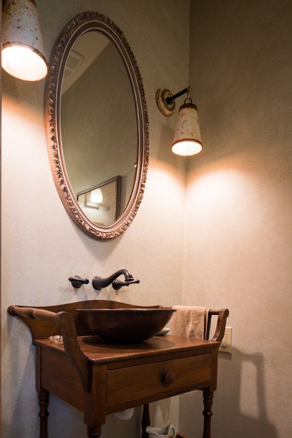 A bathroom with a sink and a mirror on the wall.
