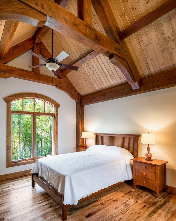 A bedroom with a bed and a ceiling fan.