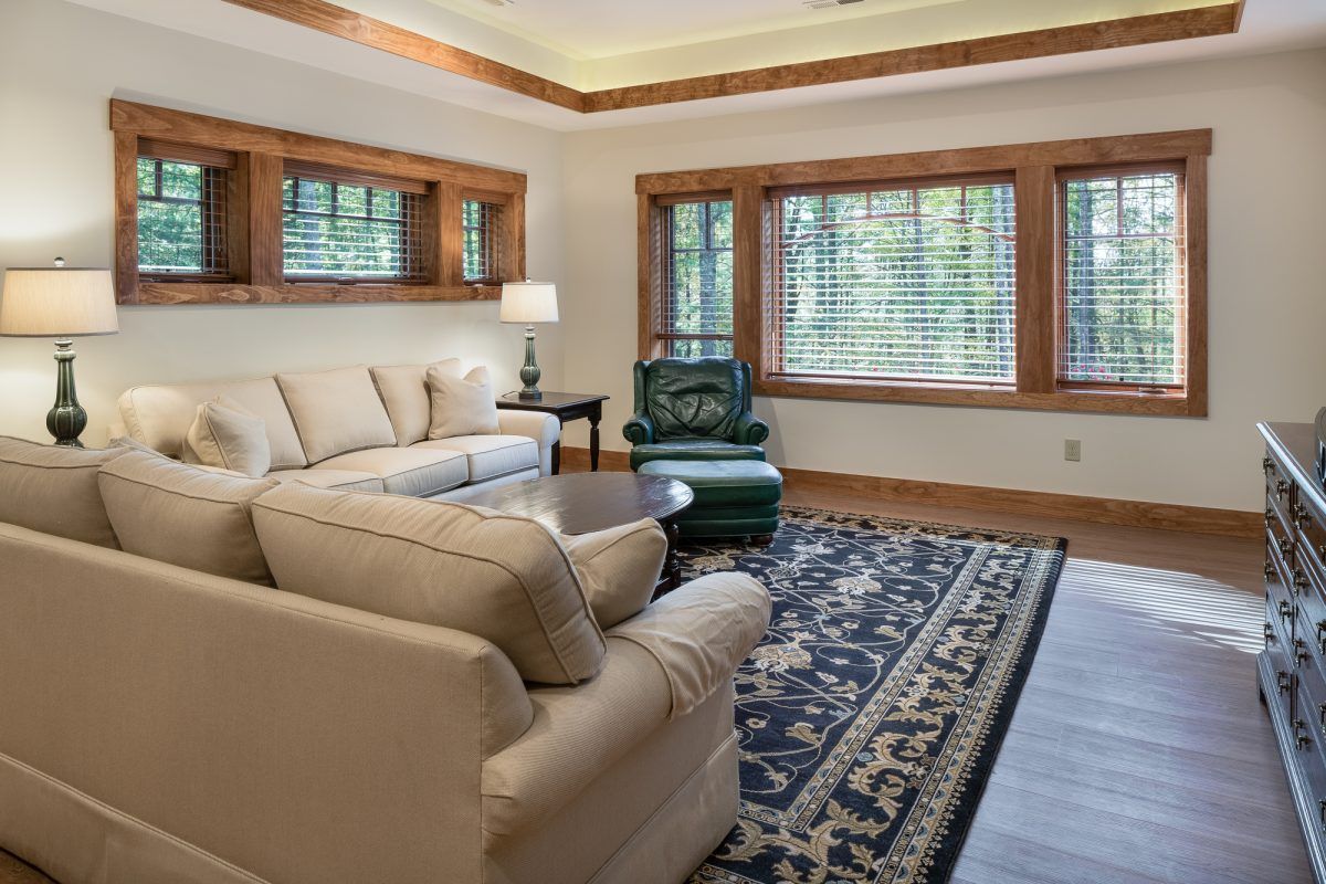 A living room with a couch, chair, and rug.