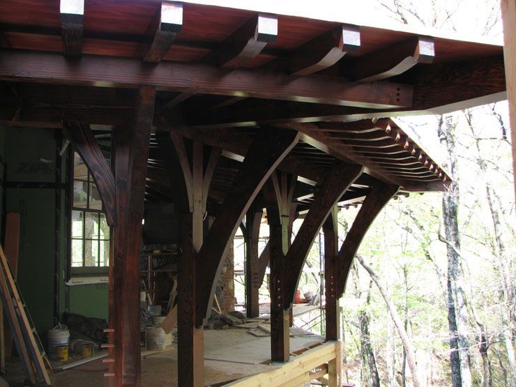 A wooden structure is being built in the woods.