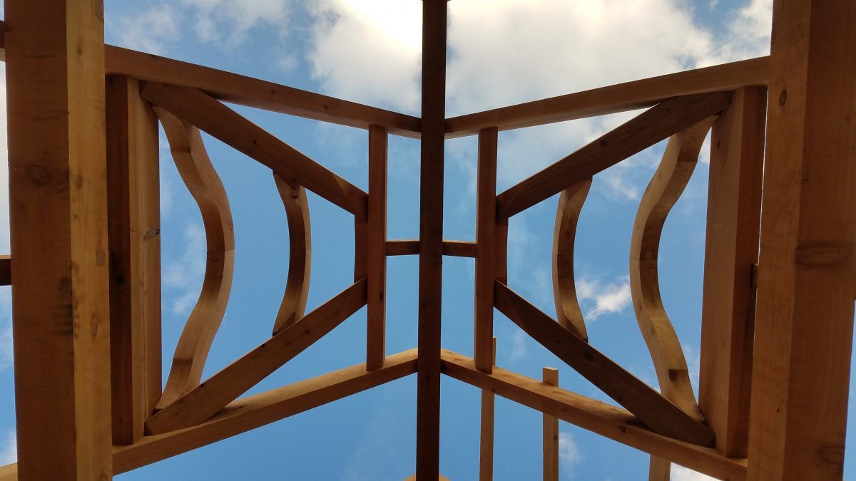 Looking up at a wooden structure with a blue sky in the background.