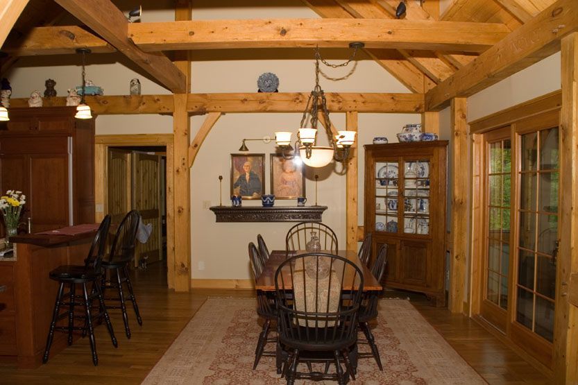 A dining room with a table and chairs in it.