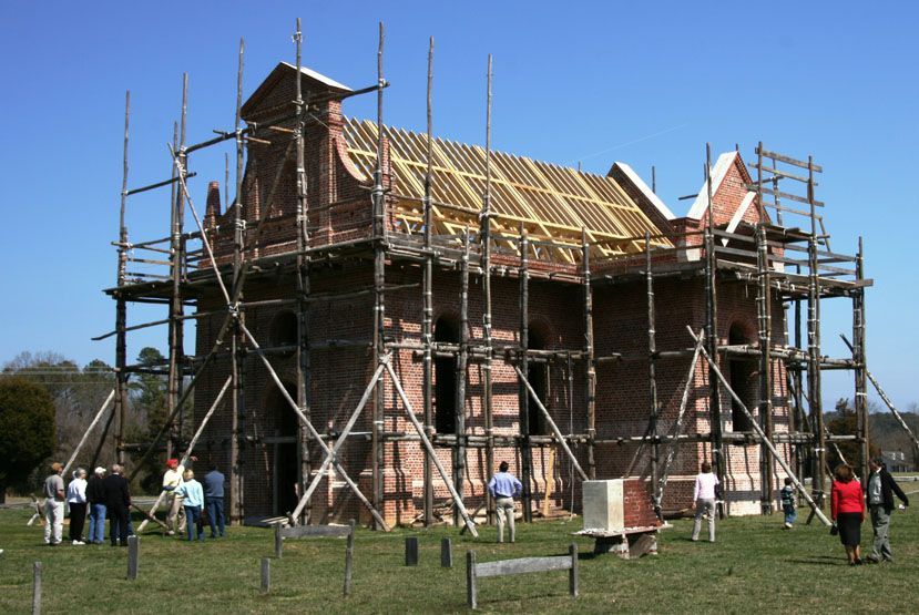 A brick building under construction with scaffolding around it.