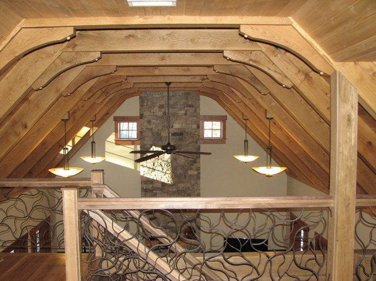 An attic with a ceiling fan and a fireplace.