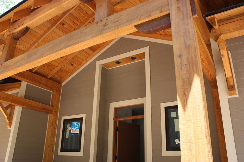 A house with a wooden porch and a wooden roof.