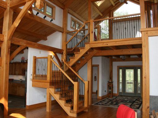 A wooden house with a staircase leading up to the second floor