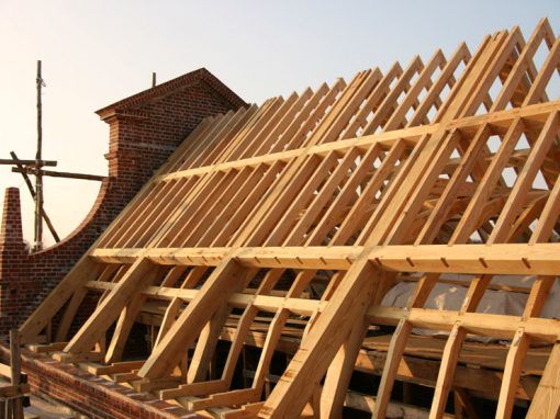A wooden structure is being built on top of a brick building