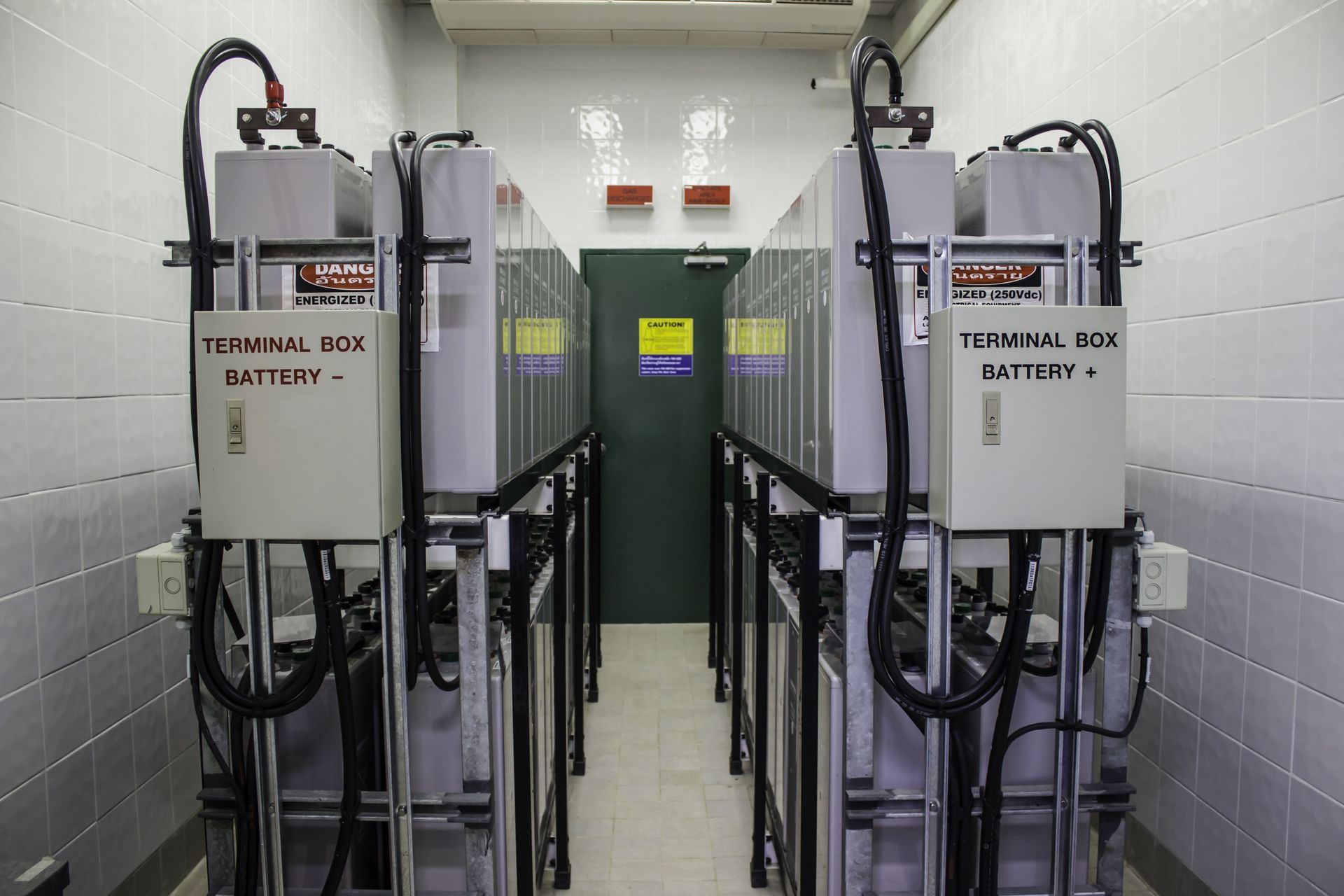 Electrical control panels and wiring mounted on a wall in an industrial room