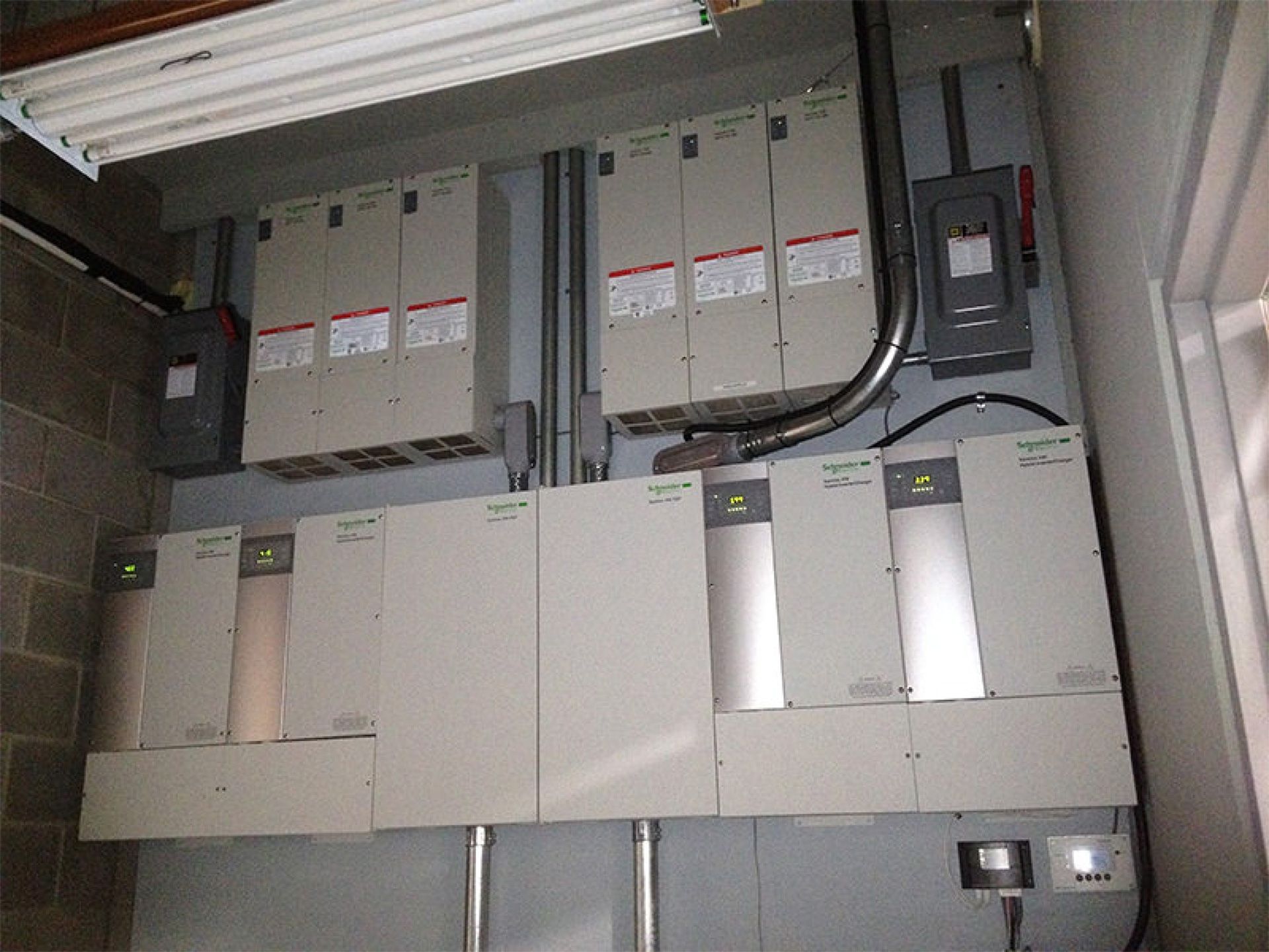 Electrical control panels and wiring mounted on a wall in an industrial room