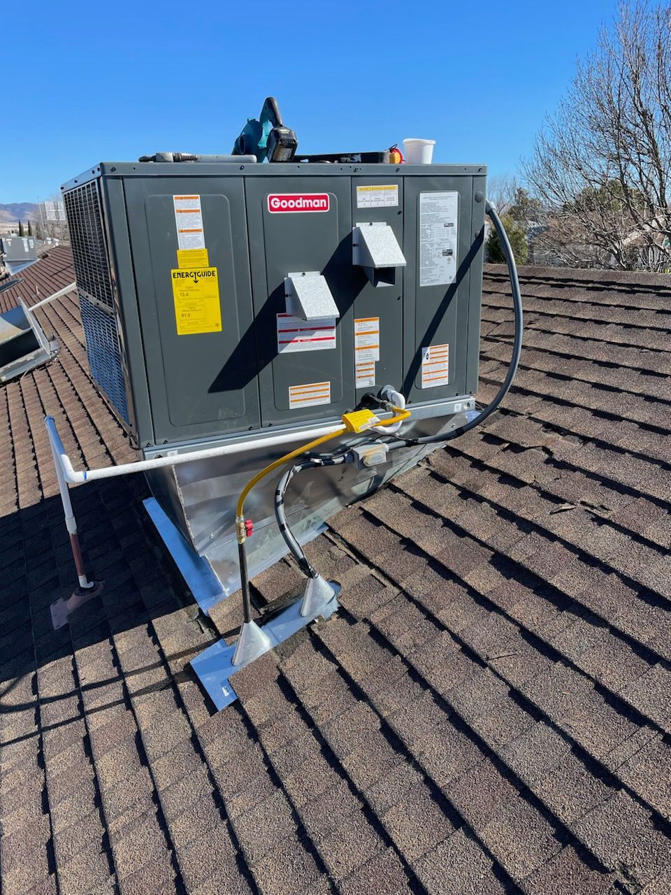 An air conditioner is sitting on top of a roof.