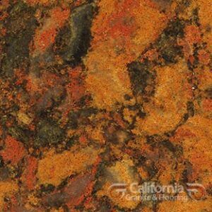 Close-up view of a granite surface with a mottled pattern of orange, rust, black, and green colors.