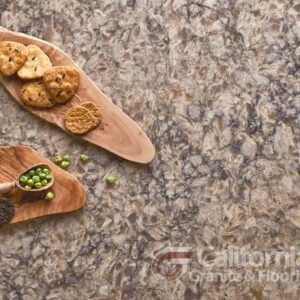 Cookies, peas on a wooden board atop a patterned countertop.