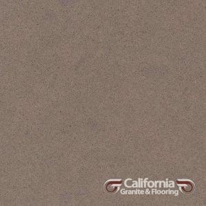 Textured, taupe-colored stone, likely granite or quartz, with the California Granite & Flooring logo in the lower right.