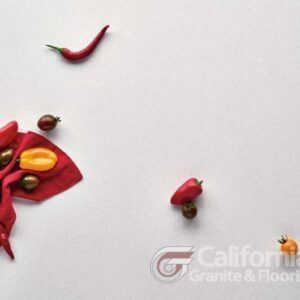 Red chili peppers and tomatoes on white surface.