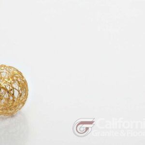 Gold wire sphere on white surface.