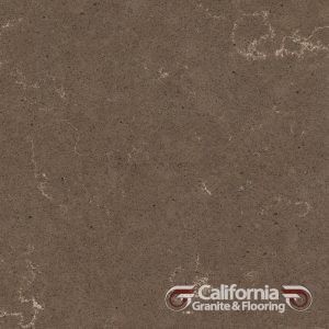 Brown quartz countertop with light veining, logo at the bottom right.