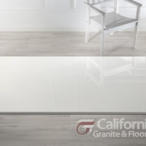 White chair on a polished white floor, possibly a showroom display, with the California Granite & Floor logo.