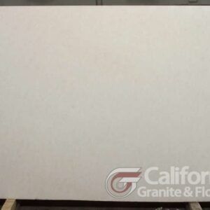 Large, off-white stone slab with subtle texture. Company logo in corner.