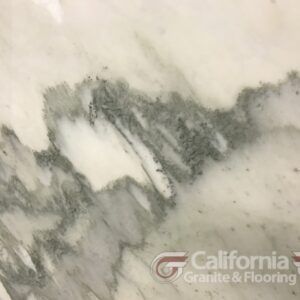 White marble with gray veining, as seen in a countertop or flooring.