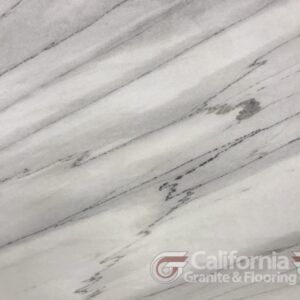 White marble with diagonal gray veining pattern, California Granite & Flooring logo.
